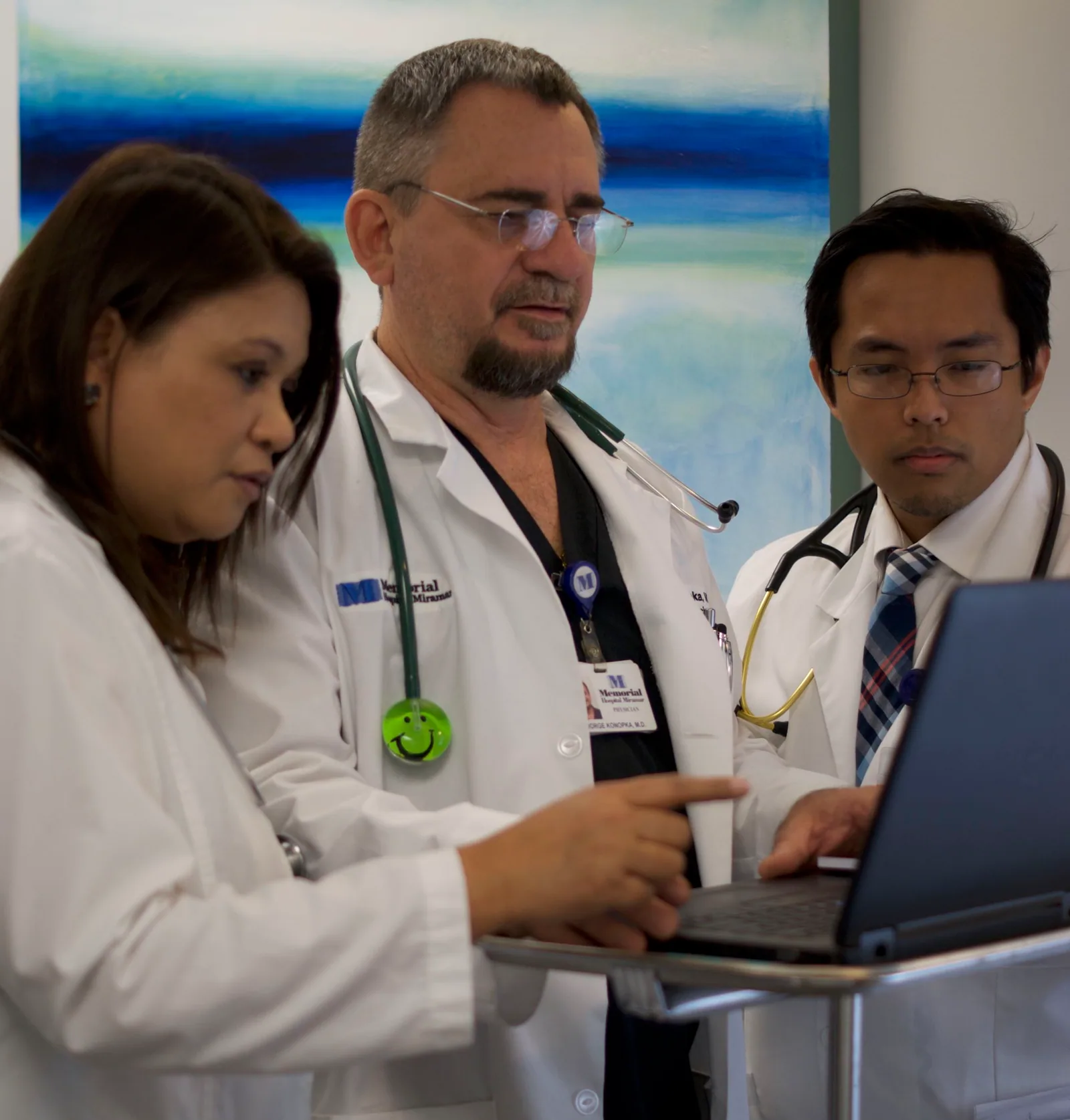 Medical team reviewing information together on a laptop